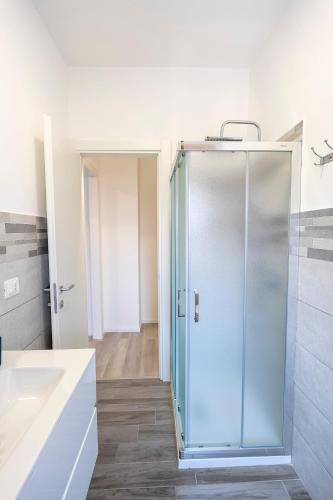 a bathroom with a glass shower and a sink at Prestige House 8 in Scalea