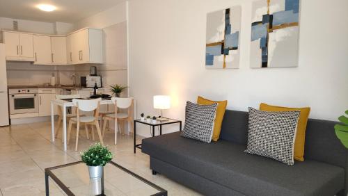 a living room with a couch and a table at Candelaria ocean views in Candelaria