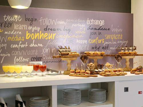 a buffet of desserts and drinks on a shelf at Ibis Sfax in Sfax