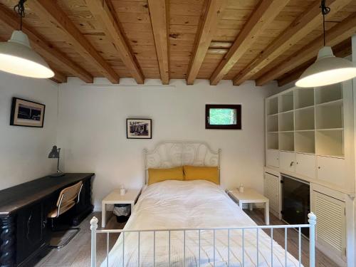 a bedroom with a white bed with two tables at Remise an der Rennbahn - umzäuntes Anwesen mit Parkplätzen, AmzonPrime, Netflix, Wii, PS2 in Hoppegarten