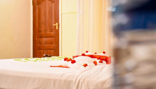 a teddy bear laying on top of a bed at Dovenest Lodge in Naivasha