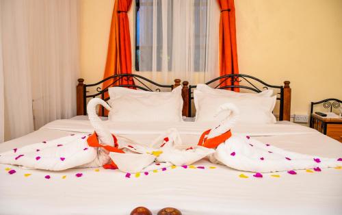 a group of swans are on a bed at Dovenest Lodge in Naivasha