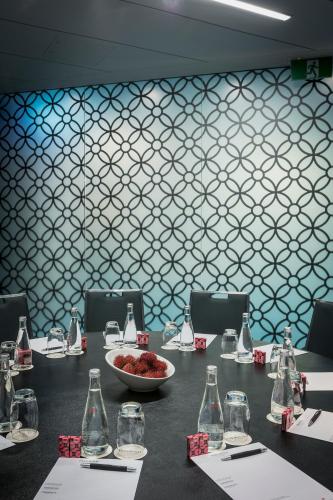 a long table with a bowl of food and bottles at PARKROYAL Darling Harbour, Sydney in Sydney