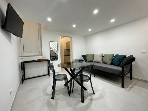 a living room with a couch and a table at Hary Home in Brindisi