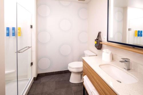 a bathroom with a toilet and a sink and a shower at Tru By Hilton Yakima Airport in Yakima