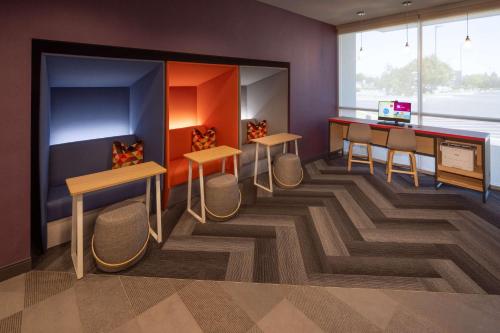 a room with tables and chairs and a desk at Tru By Hilton Yakima Airport in Yakima