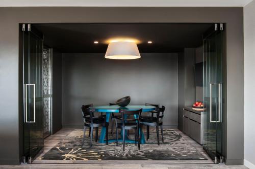 a dining room with a blue table and chairs at PARKROYAL Darling Harbour, Sydney in Sydney