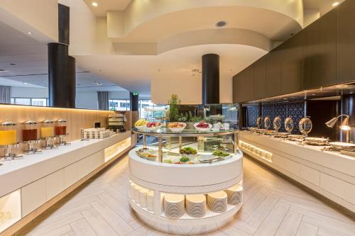 a buffet line in a restaurant with food on display at PARKROYAL Darling Harbour, Sydney in Sydney