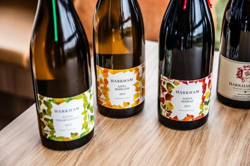three bottles of wine sitting on a table at Harkham Lodge in Pokolbin