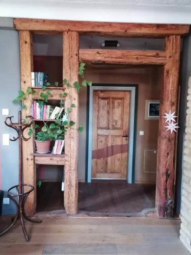 a wooden doorway into a room with a book shelf at Lehm-Fachwerk-Denkmal in Arnshall