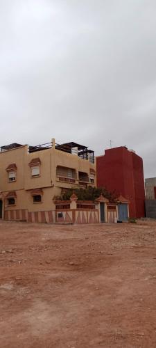 a building in the middle of a dirt field at REPOS SURF HOUSE 2 in Sidi Ifni