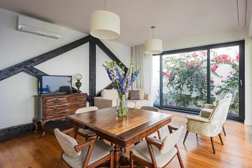 a living room with a wooden table and chairs at 54 São Paulo - Exclusive Apartment Hotel in Lisbon