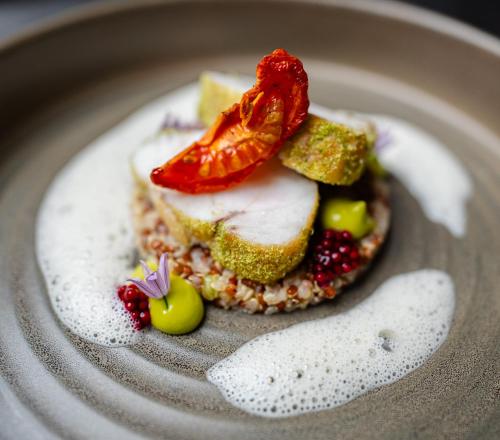 a plate with a piece of food with fruit on it at Hotel Jaufentalerhof in Racines