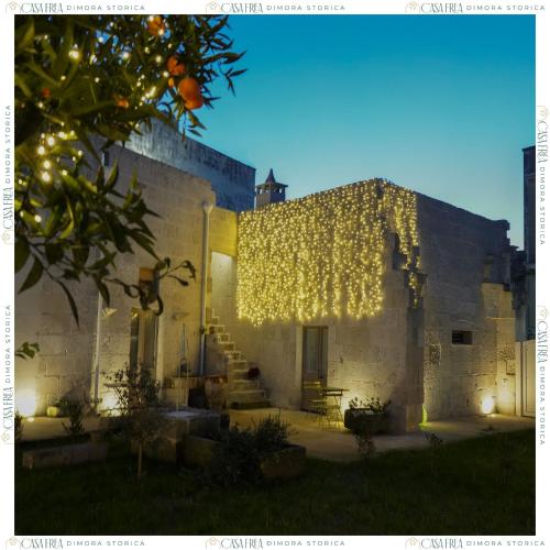 a building with a bunch of lights on it at Casa Frea Dimora Storica in Martano