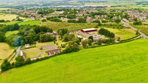 an aerial view of a large green field with a house at Garnock 3 in Beith