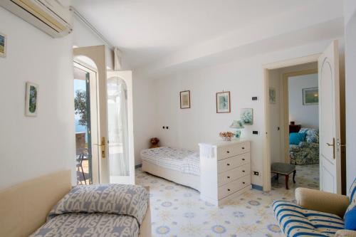 a bedroom with a bed and a dresser at Villino Blu in Praiano