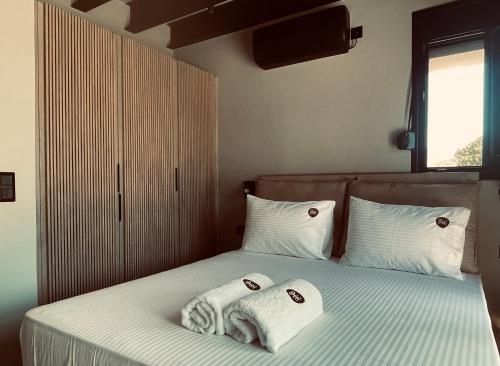 a bedroom with two towels on a bed at Petras Estate in Skala Eresou