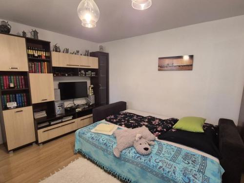 a bedroom with a bed with a teddy bear on it at Szahara Vendégház in Kerekegyháza