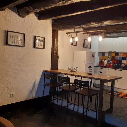 a kitchen with a large wooden table and chairs at Casa do Alambique in Castro Daire