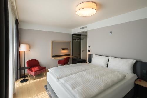 Postel nebo postele na pokoji v ubytování IntercityHotel Heidelberg