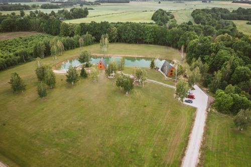 an aerial view of a large field with a house at Poilsio Vingis in Liūnai