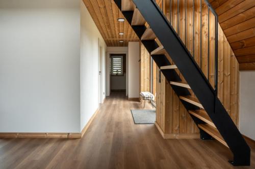 a staircase in a house with wooden floors at Poilsio Vingis in Liūnai