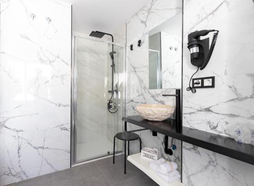 a bathroom with a shower and a black counter at HOSTAL LUXURY NIT I DIA in Altea