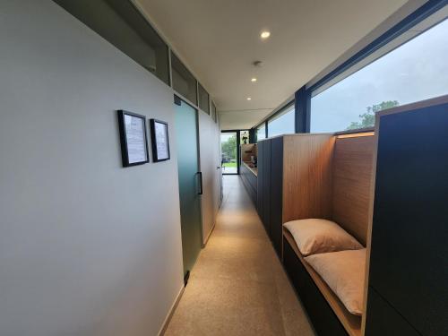 a hallway of a house with a couch and a window at Lodge 323 in Malmedy