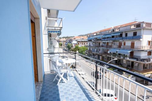 a balcony with a table and chairs and buildings at Prestige House 9 in Scalea
