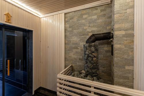 a stone fireplace in a house at Севеней Готель in Bukovel