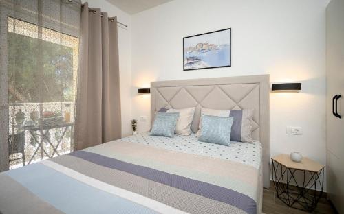 a bedroom with a large bed and a window at Villa Vista Hvar in Jelsa