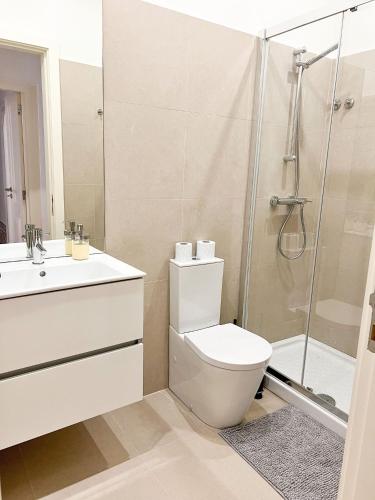 a bathroom with a toilet and a shower at Large apartment on Rua Augusta in Lisbon