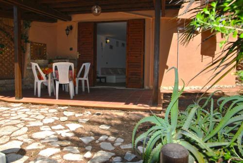 a patio with a table and chairs on a porch at Casa Marilena vista mare in Sperlonga