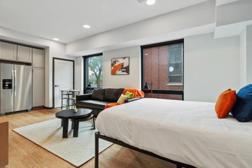 a bedroom with a large bed and a couch at CozySuites on Mass with garage parking #14 in Indianapolis