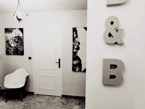 Cette chambre dispose d'une porte et d'une chaise blanches. dans l'établissement Bed and Break Annecy, appartement 90m2 avec parking, balcons, à Annecy