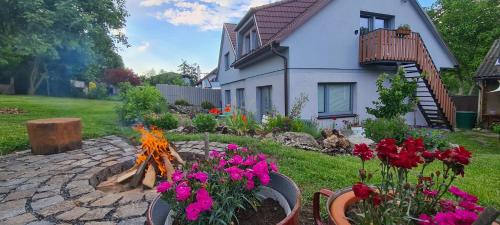 a garden with flowers in front of a house at Votice Luční in Wotitz
