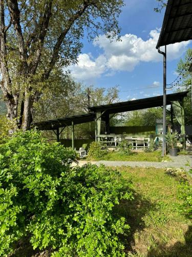 a pavilion with a picnic table in a park at View Racha in Ambrolauri