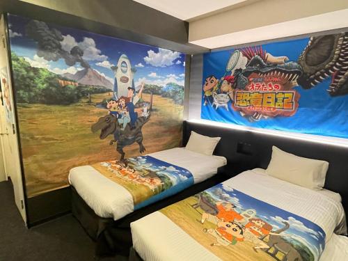 two beds in a room with a mural at Henn na Hotel Tokyo Asakusabashi in Tokyo