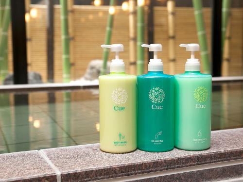 three bottles of soap are sitting on a counter at Hotel Route-Inn Fuji Chuo Koen Higashi in Fuji