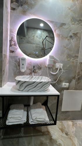 a bathroom with a sink and a mirror at Hotel Arberia in Tirana