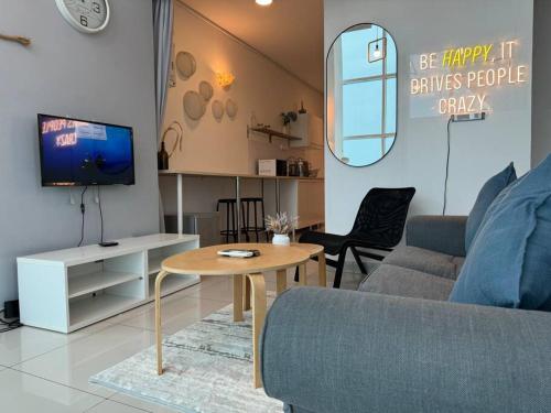 a living room with a couch and a table at NEW - Panorama Komtar SeaView Meritime Suites in Jelutong