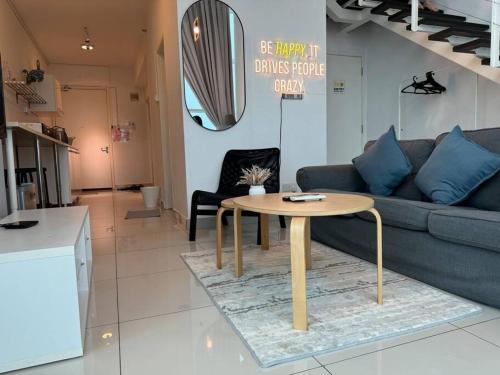 a living room with a couch and a table at NEW - Panorama Komtar SeaView Meritime Suites in Jelutong