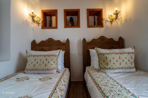 Ein Bett oder Betten in einem Zimmer der Unterkunft Riad Lella Chama