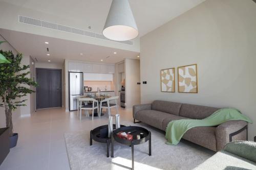 a living room with a couch and a table at Stunning Beachfront 1BR Apartment in Palm Jumeirah By ĀYA Boutique in Dubai