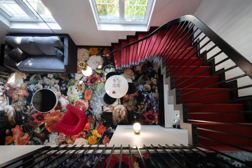 a room with a staircase with a floral wallpaper at Amsterdam Plaza Hotel & SPA in Palanga