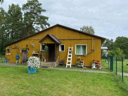a large wooden house with a yard at Torgu Royal Guesthouse in Iide