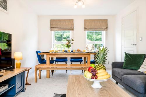 a living room with a table with a bowl of fruit at Argus 4-Bed Haven, Contractor, Families, Industrial Area in Hemel Hempstead