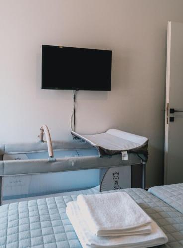 a hospital room with two beds and a tv on the wall at Charys Premium Home in Preveza