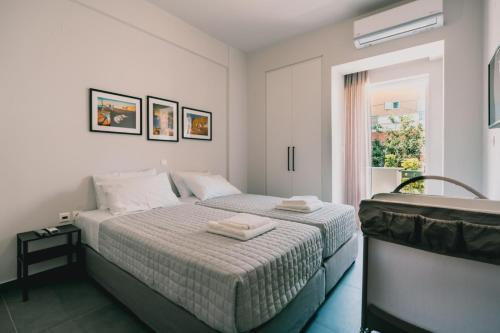 a bedroom with two beds and a window at Charys Premium Home in Preveza