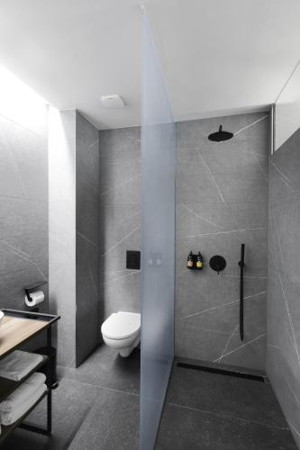 a bathroom with a toilet and a shower at Hotel Prokop Square in Prague